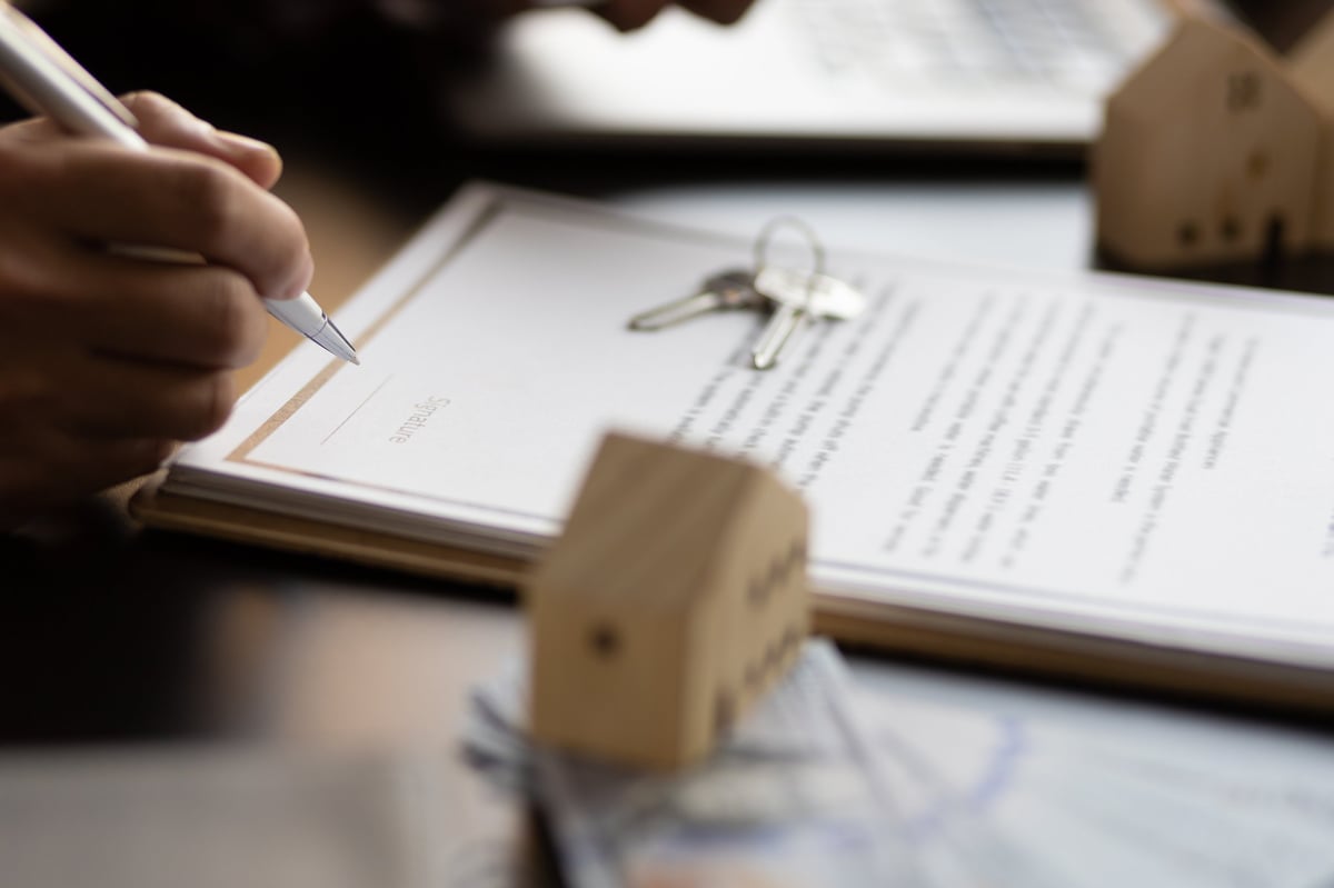 Businessman signing a contract for a purchase agreement mortgage and rental housing